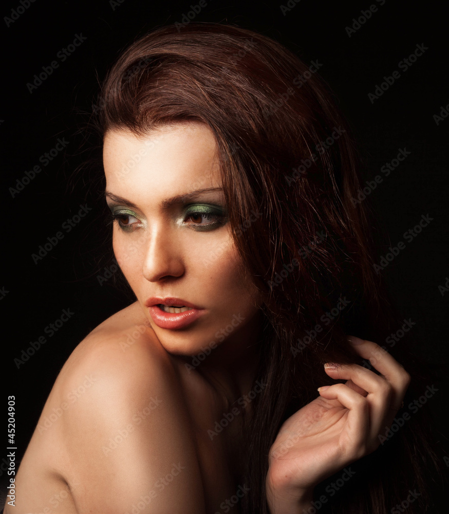 Fototapeta premium Beautiful woman with trendy makeup in a studio posing