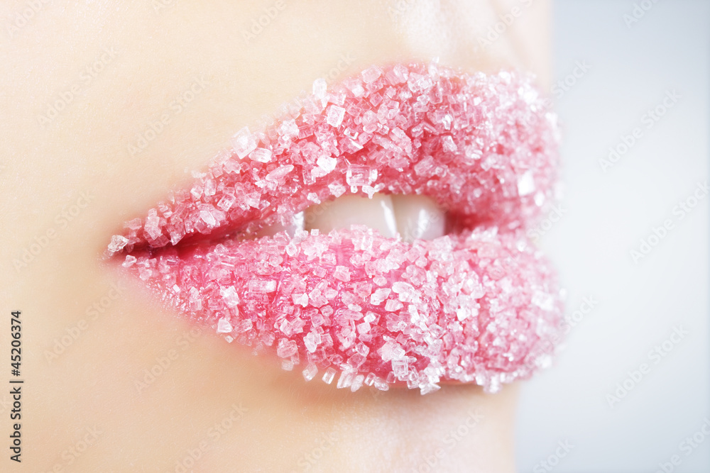Fototapeta premium Woman's lips strewed with sugar