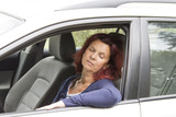 Tired woman driver sleeps in the car