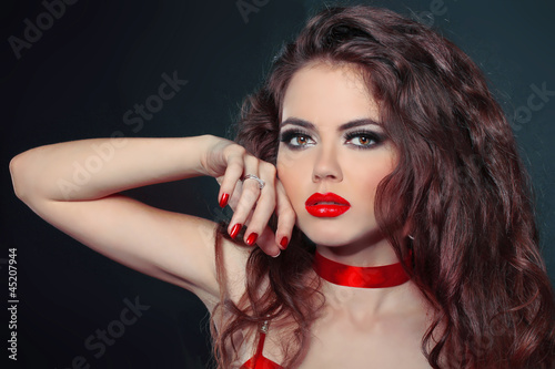 close-up portrait of woman with red lips and nails