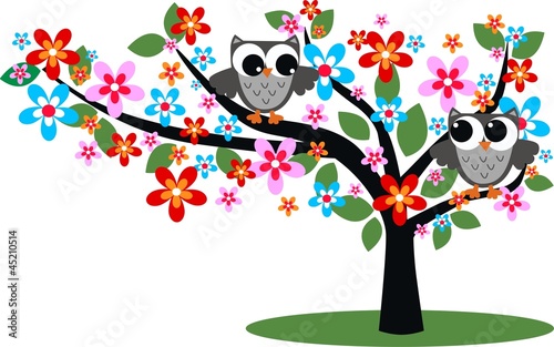 two owls sitting in a tree