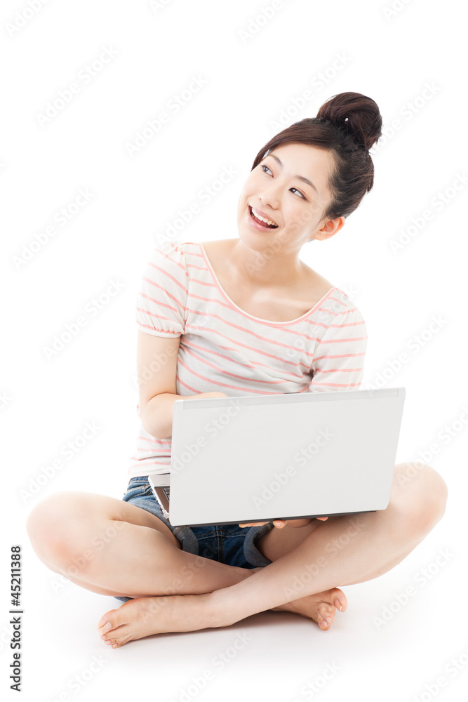 Naklejka premium Beautiful young woman using a laptop. Portrait of asian.