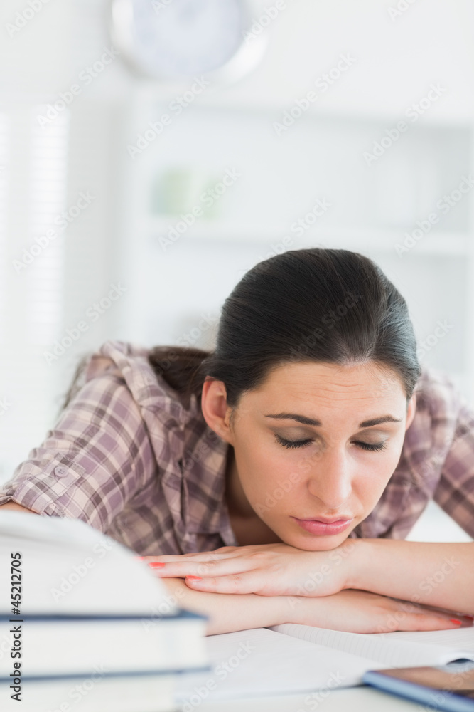 Woman with closed eyes leaning on a table Woman with closed eyes leaning on a table