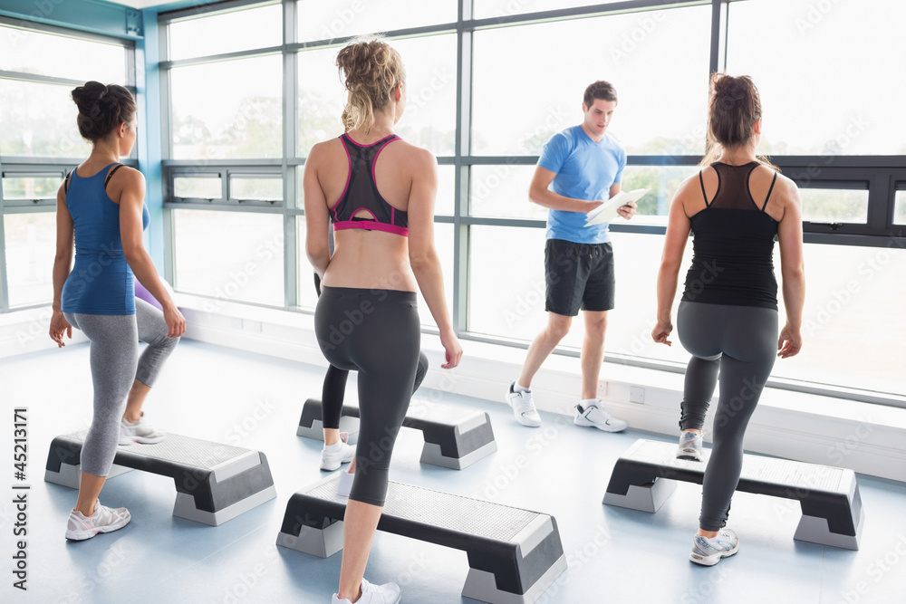 Trainer teaching his aerobic class Trainer teaching his aerobic class