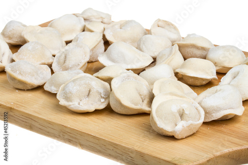 Some raw dumplings on the wooden board