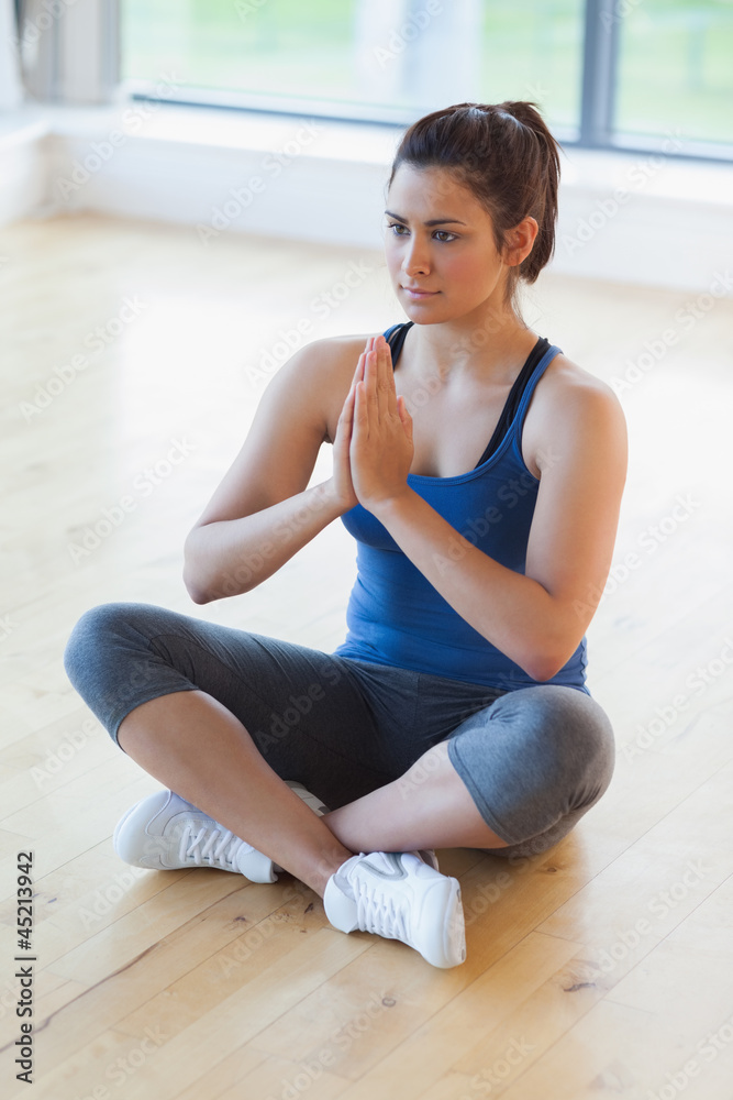 Woman sitting in easy yoga pose Woman sitting in easy yoga pose