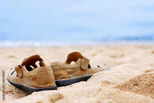Men's shoes on the sand - the traveler