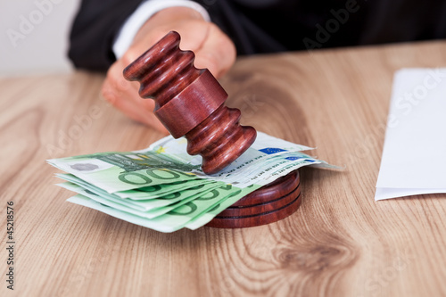 Male Judge Striking The Gavel On Euro Note