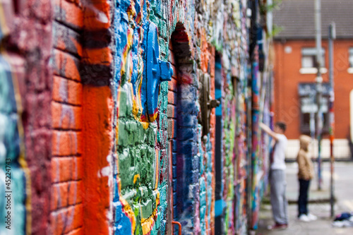 Graffiti wall with painters photo