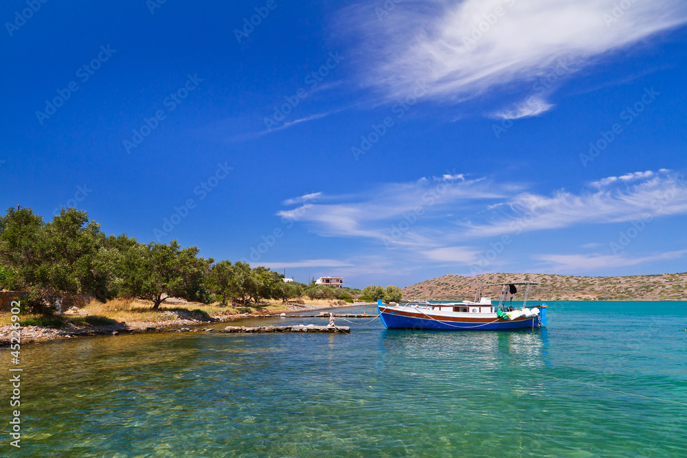 Small fishing boat at the coast of Crete, Greece Small fishing boat at the coast of Crete, Greece