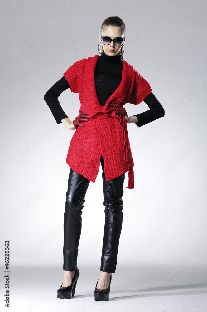 fashion model in red clothes posing on light background fashion model in red clothes posing on light background