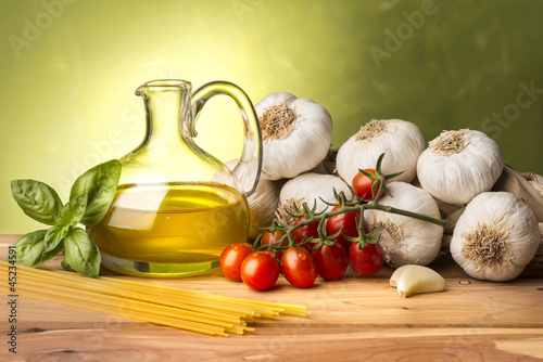 stil life with olive oil,vegetables on wood table