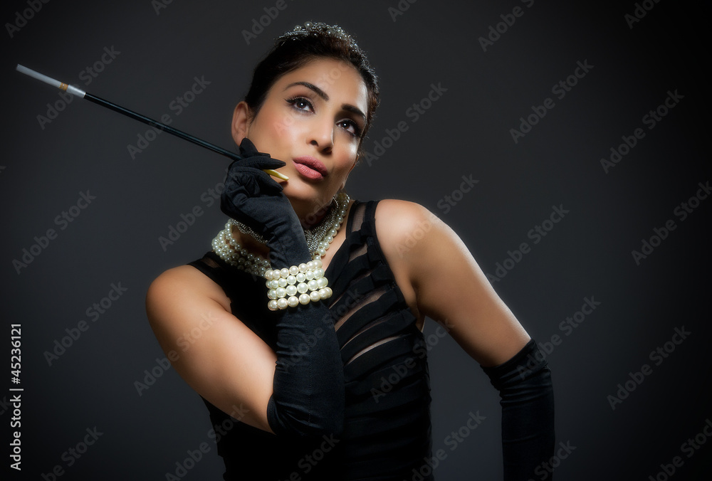Stylish young woman in black dress retro style