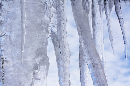 Melting icicles on a background sky