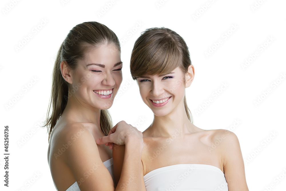 Portrait of two young beautiful women on white background smilin Portrait of two young beautiful women on white background smilin