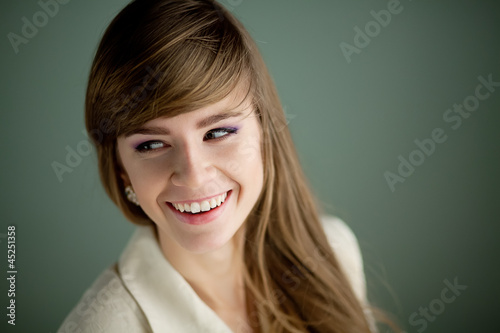 Portrait of young beautiful woman smiling at cameta photo