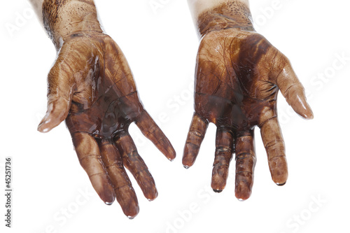 Human hands stained with black petroleum isolated on white
