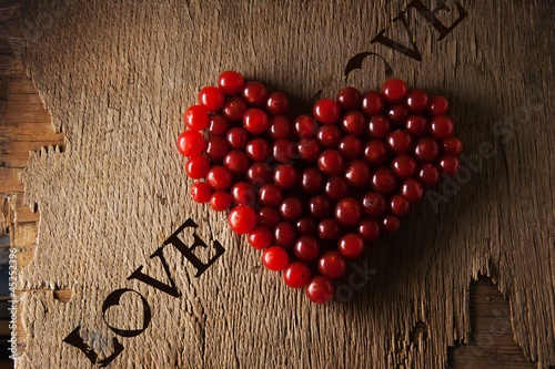 Canvas Print Viburnum in heart shape on wooden surface. love concept.