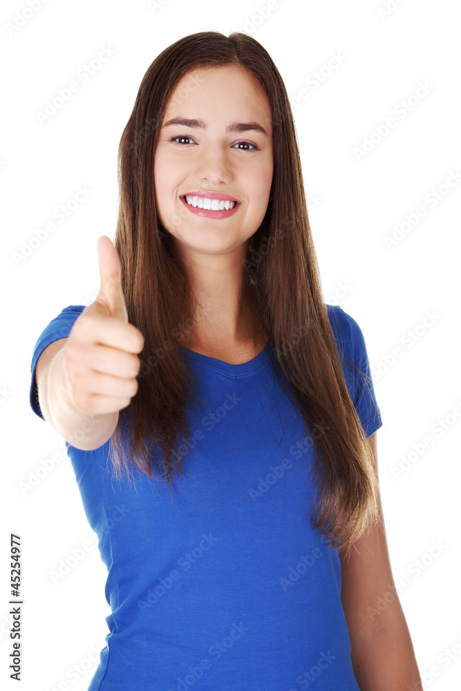 Beautiful young woman in casual clothes gesturing thumbs up. Beautiful young woman in casual clothes gesturing thumbs up.