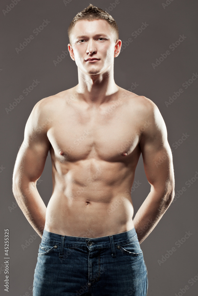 Fototapeta premium muscular man holding hands on waist