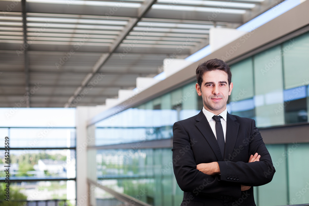 Portrait of a happy young business man at modern office