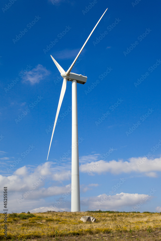 Windmill in the top of a mountain against beautiful sky Windmill in the top of a mountain against beautiful sky