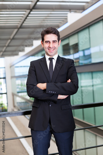 Portrait of a smiling young business man at modern office