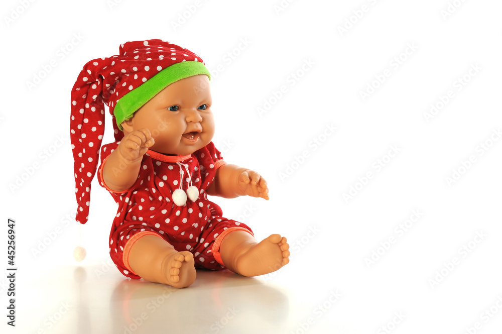 Baby doll with red dress sitting isolated white bacground Baby doll with red dress sitting isolated white bacground