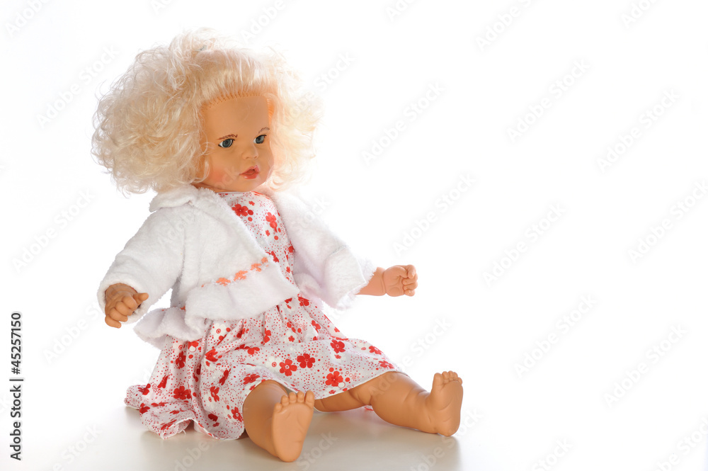 Belonde baby doll sitting isolated white bacground Belonde baby doll sitting isolated white bacground