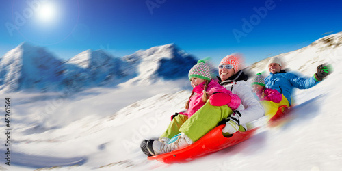 Winter, snow, family sledding at winter time photo