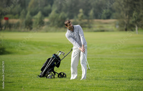 Golf player strikes a good shot