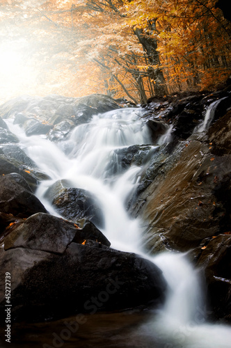 waterfall on  river through...