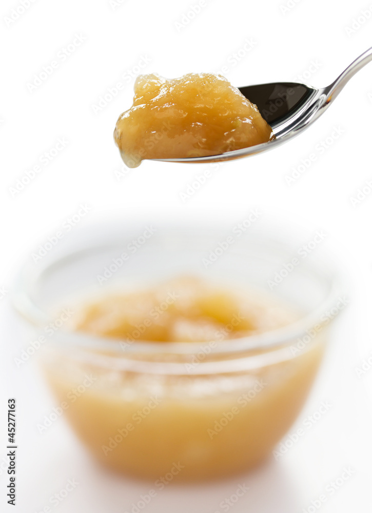 Apple jam on spoon isolated on white background Apple jam on spoon isolated on white background