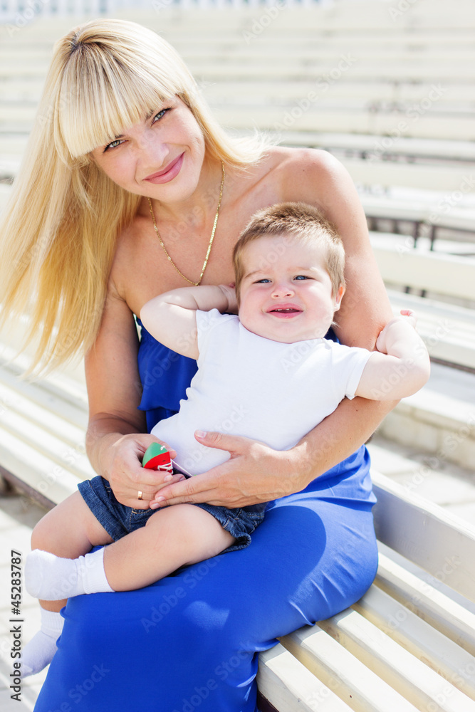 Young mother with her little son in summer park Young mother with her little son in summer park