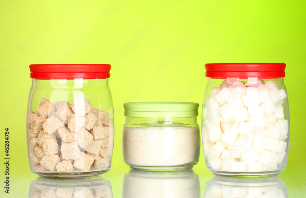 Jars with brown cane sugar lump, white crystal sugar and white Jars with brown cane sugar lump, white crystal sugar and white