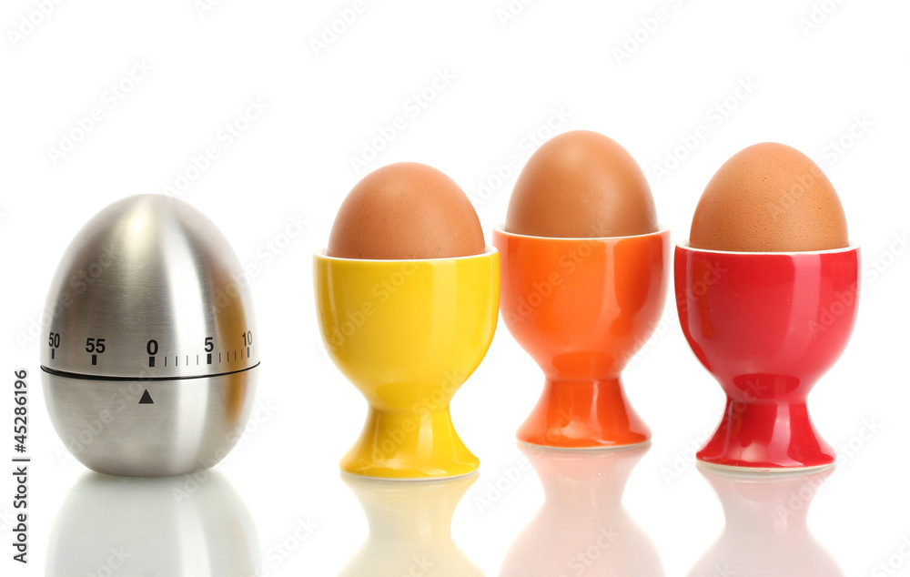 egg timer and egg in color stand isolated on white egg timer and egg in color stand isolated on white