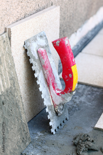 Obraz na plátne mortar on wall construction notched trowel