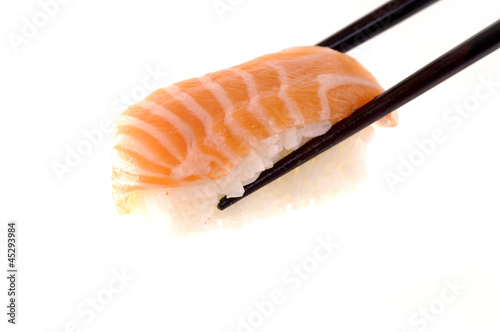 Sushi with chopsticks shot on white