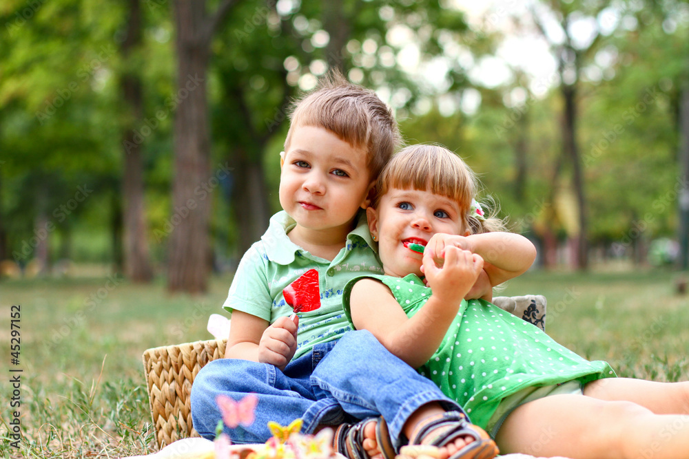 Caucasian little boy and girl eating sweets Caucasian little boy and girl eating sweets
