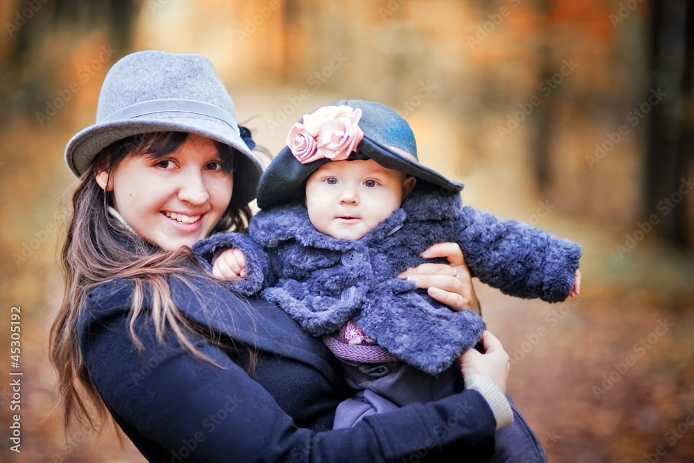 Little girl and her mother portrait in autumn park Little girl and her mother portrait in autumn park
