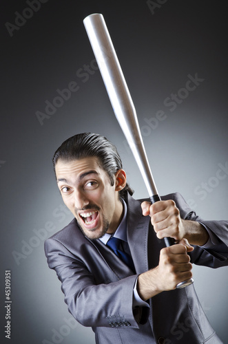 Angry businessman with bat on white © Elnur