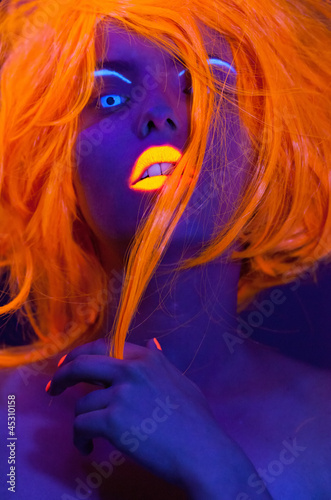 Uv light portrait, woman with glowing accessories and make up