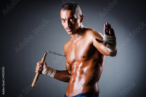 Strong man with nunchaku photo