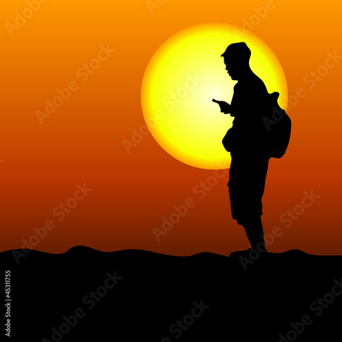 man in the desert looking at mobile