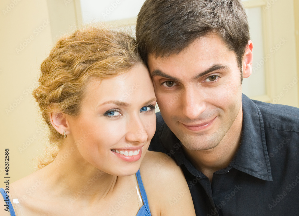 Cheerful smiling young couple, indoors Cheerful smiling young couple, indoors