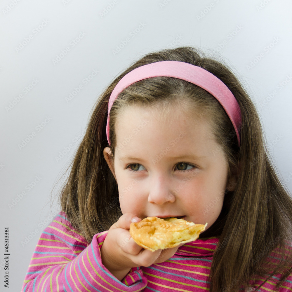 Pretty little girl eats a pancake for breakfast Pretty little girl eats a pancake for breakfast