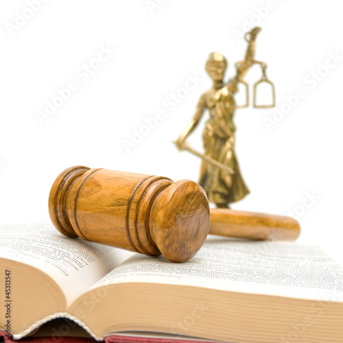 Photos gavel, law book, a statue of justice on a white background