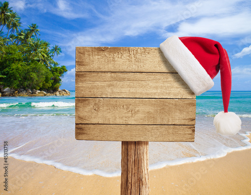 tropical beach wooden signboard with Christmas hat