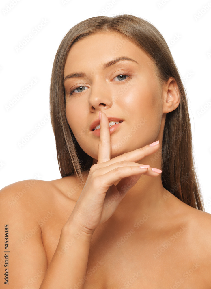 woman with finger on lips woman with finger on lips