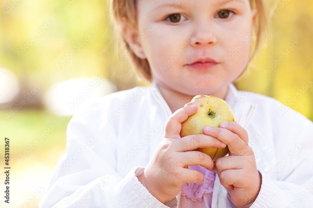 beautiful little girl eating apple in the autumn forest beautiful little girl eating apple in the autumn forest